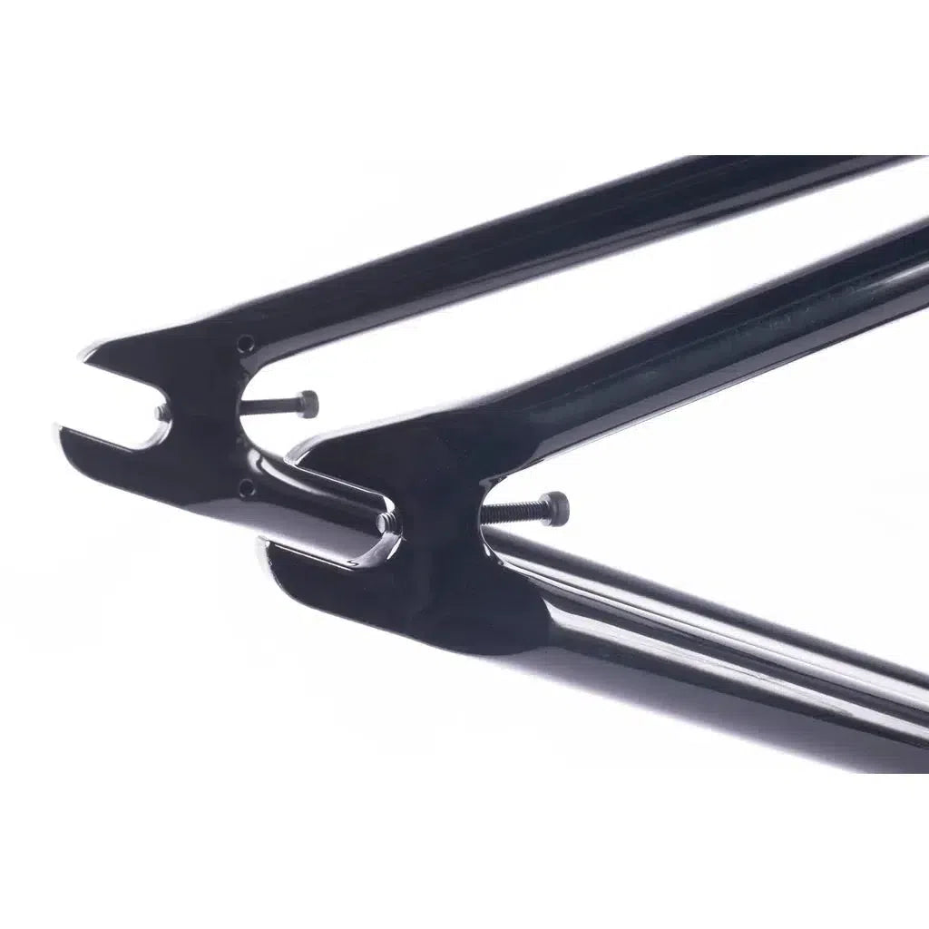 Close-up of black fork ends on Cult Dak Frame with screws inserted against a white background, highlighting its sleek design.
