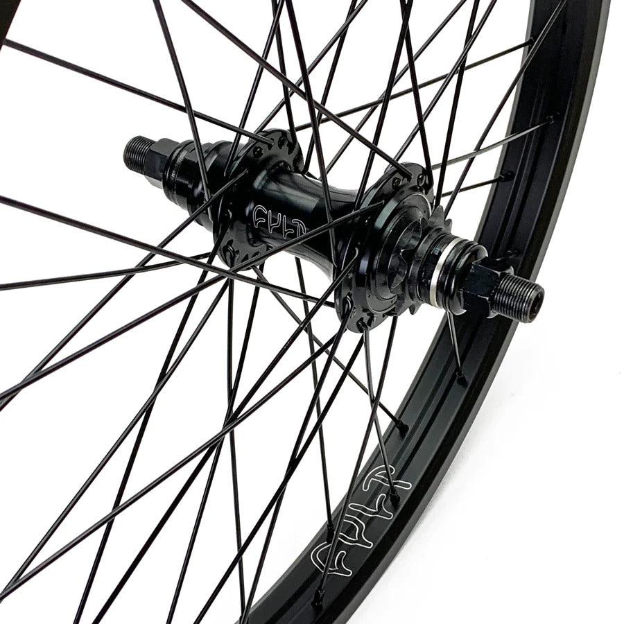 Close-up of the Cult Devotion 20-Inch Rear Cassette Wheel in black, highlighting the spokes and double-walled rim where the logo is visible. The central hub includes a sealed 9t driver designed for enhanced performance.