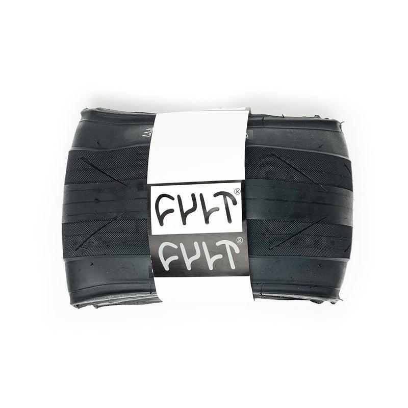 The Cult Fast And Loose Folding Tyre is a folded black bicycle tire, recognized for low rolling resistance, with a white paper band labeled "CULT" wrapped around its center.