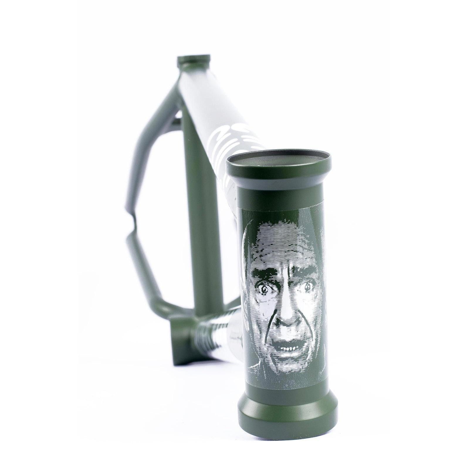 Close-up of a green Cult Heavens Gate Frame (Brandon Begin Signature), featuring a black and white illustration of a man's face on the head tube.