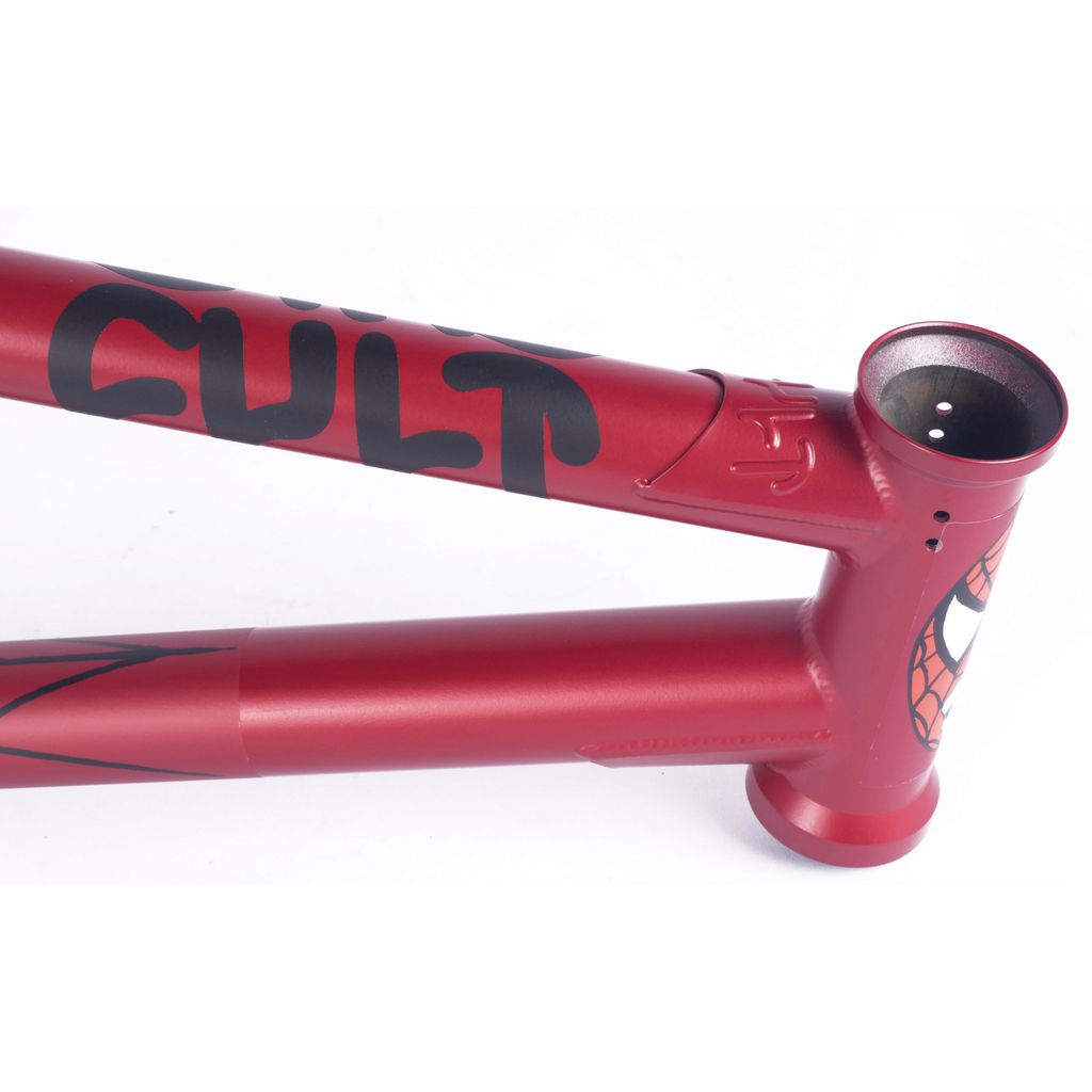 The Cult Heavens Gate Frame in the Marcel Anderson Colourway is a red BMX frame with black and red Spiderman graphics, boasting a web design and the word "CULT," influenced by the signature style of Brandon Begin.