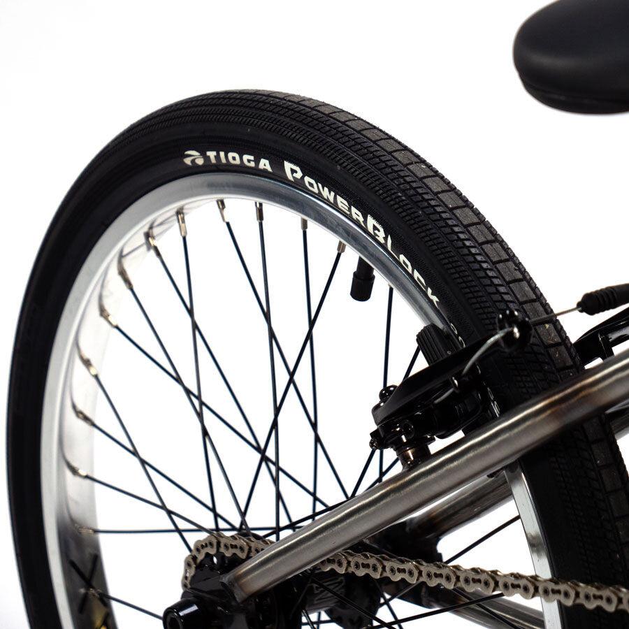 A close up of a Cult Vick Behm Custom Race Bike with a chain on it.