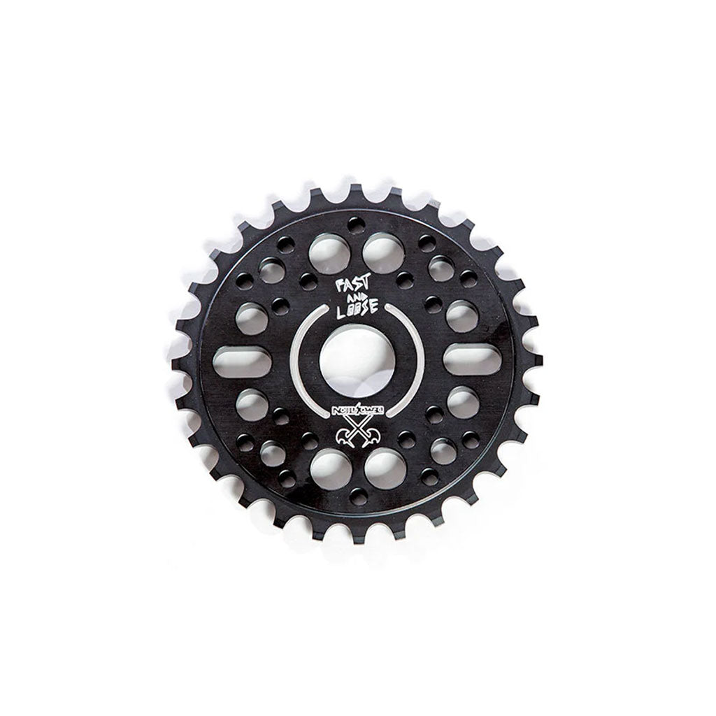 Close-up of a black Demolition Fast and Loose Sprocket featuring a circular pattern of holes. The sprocket is adorned with the text "FAST AND LOOSE.