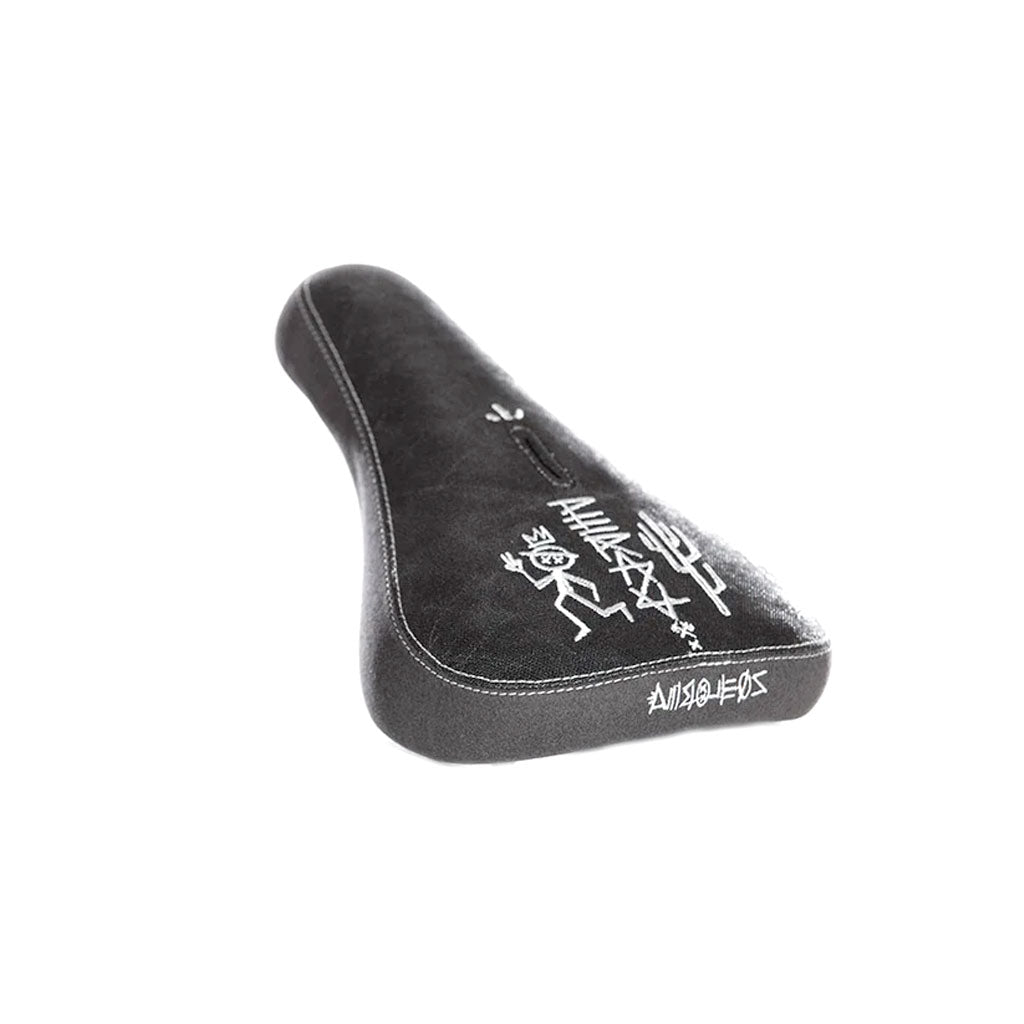 The Demolition Kevin Peraza Seat is a black bicycle seat with white graffiti-like designs on the top and sides, featuring a pivotal design.