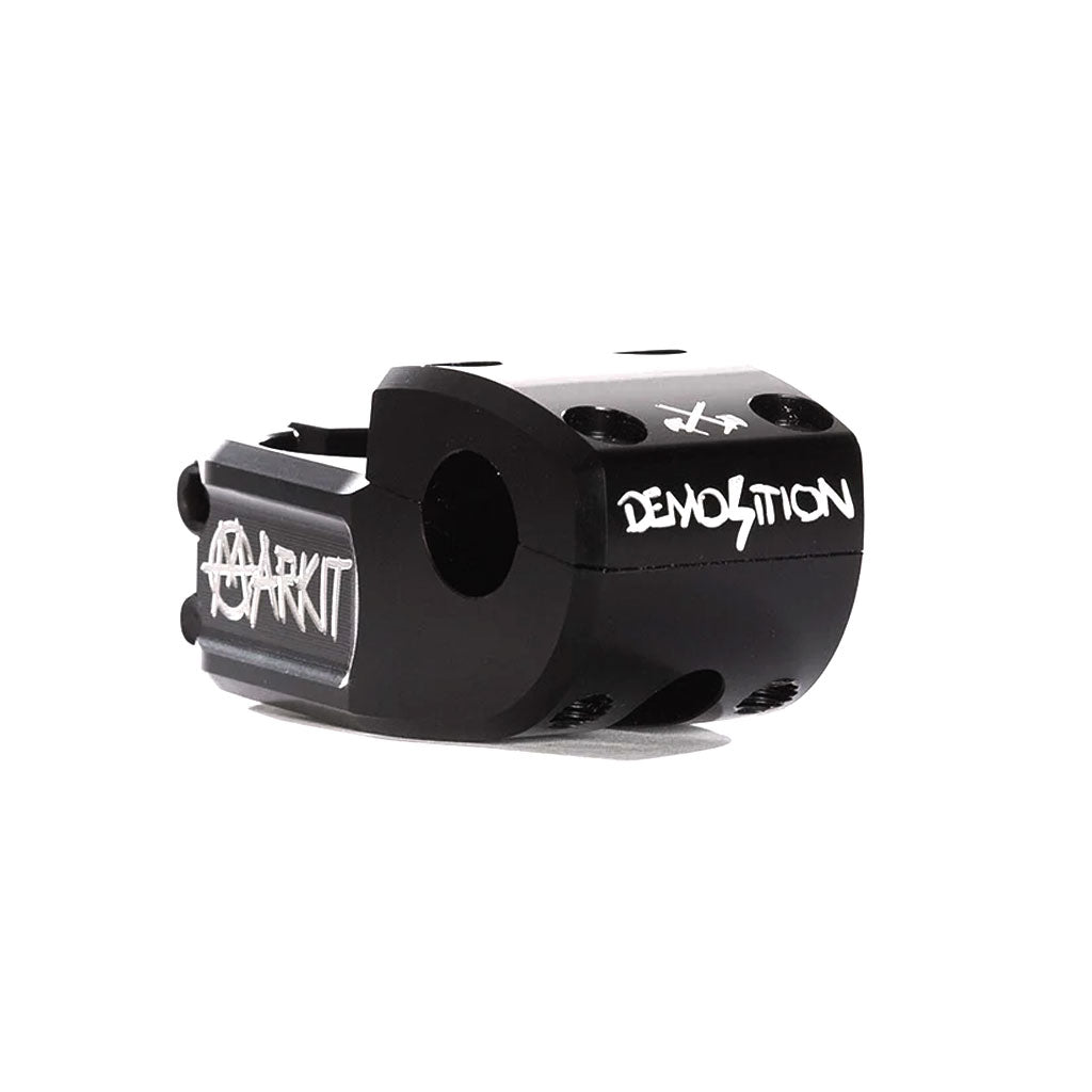 The Demolition X Markit Top Load Stem is a lightweight, black BMX alloy stem featuring "MARKIT" and "DEMOLITION" in white lettering. It showcases multiple bolt holes for attachment and extensive machining for enhanced durability.