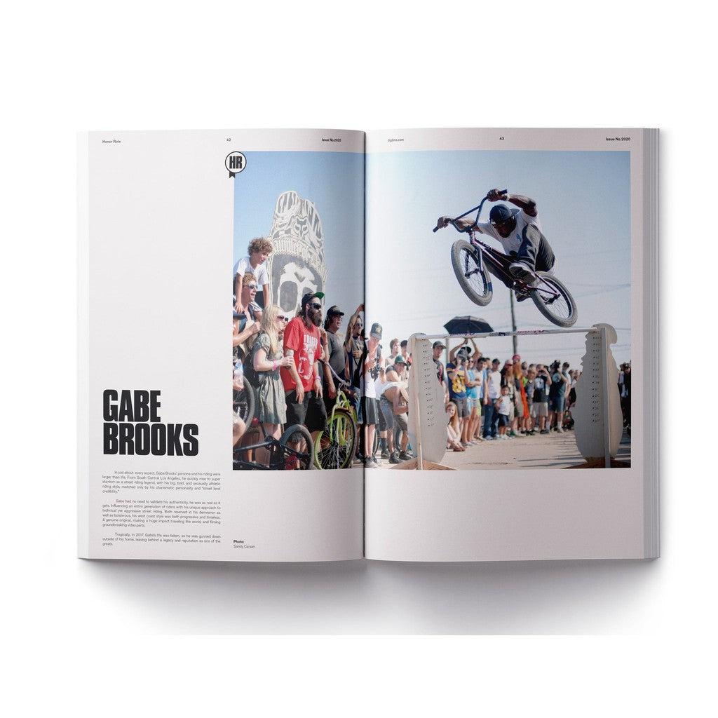 A DIG Book 2020 - Photo Annual spread featuring a dynamic photograph of a man riding a bike, showcasing his athleticism and freedom.