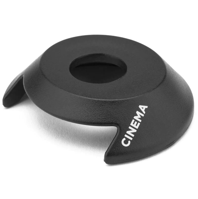A black circle with the word "cinema" engraved on it, featuring the Cinema DR Hub guard.
