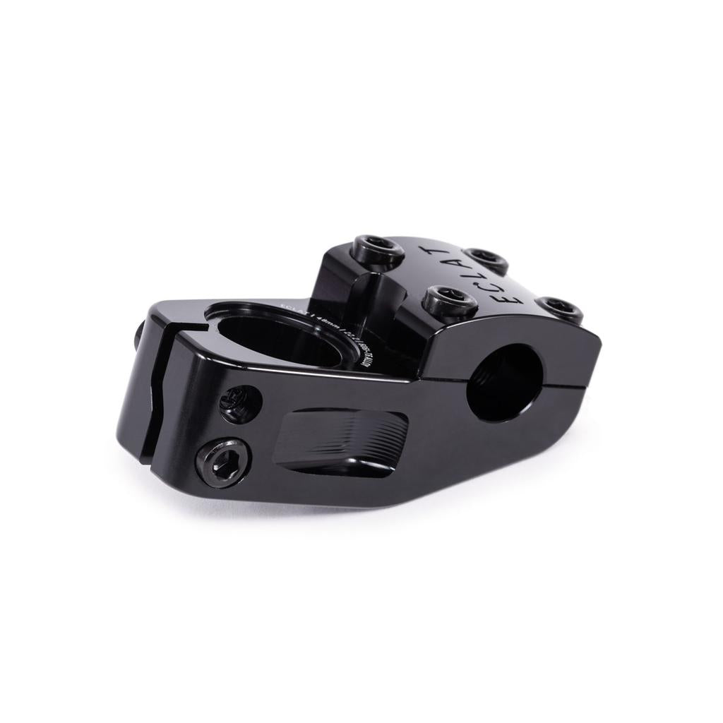 The Eclat Domain Top Load Stem is a black BMX stem with visible screws, designed to connect handlebars to the frame. It offers oversize clamping options for enhanced control and stability during rides.
