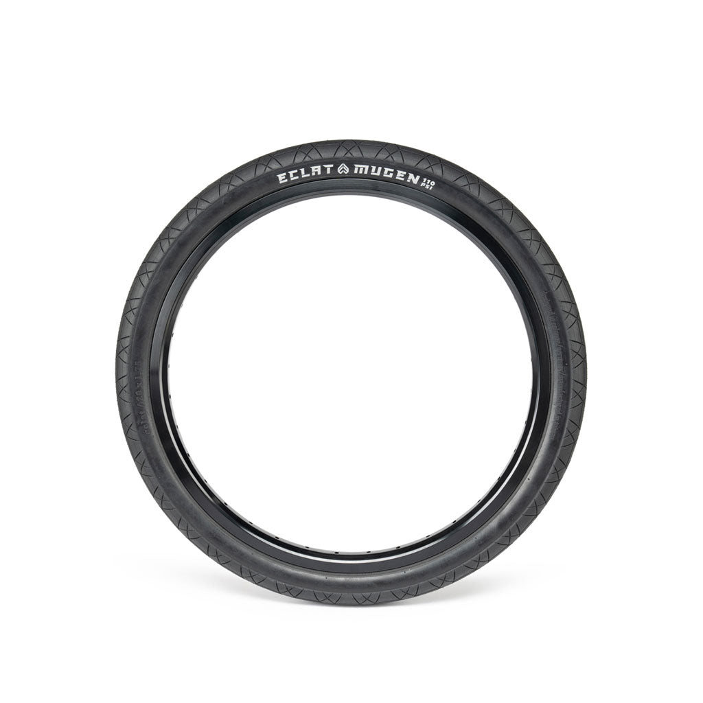 The ECLAT Mugen Flatland Tyre, perfect for flatland riding, is displayed against a white background, highlighting its tread pattern and sidewall branding.