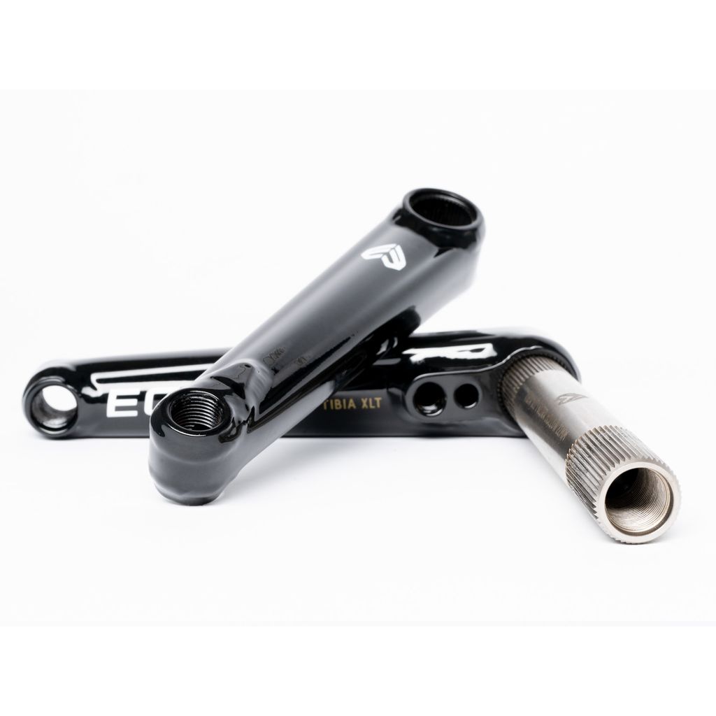 Eclat Tibia XLT Cranks with white logos, one with a hollow spindle, rest on a white surface.
