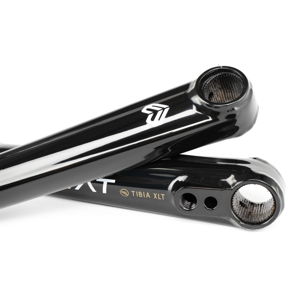 Close-up of two black Eclat Tibia XLT Cranks labeled "Tibia XLT," showcasing a clean design and machining details. This BMX crankset epitomizes quality and precision, ideal for riders seeking a lightweight crank solution.