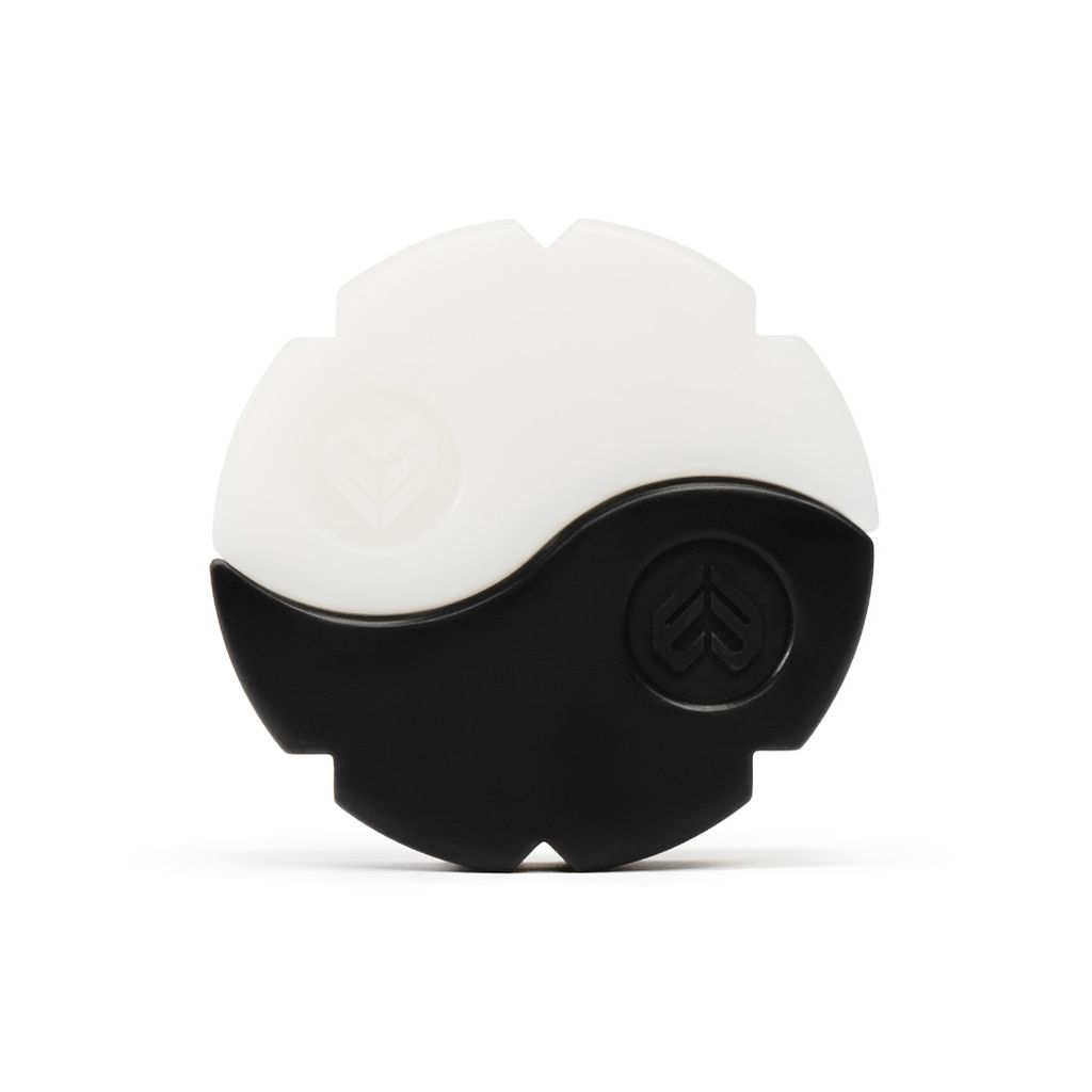 An Eclat Zen Wax divided into black and white halves, resembling a yin-yang symbol, with embossed tree-like icons on each section and an ergonomic grip for easy handling.