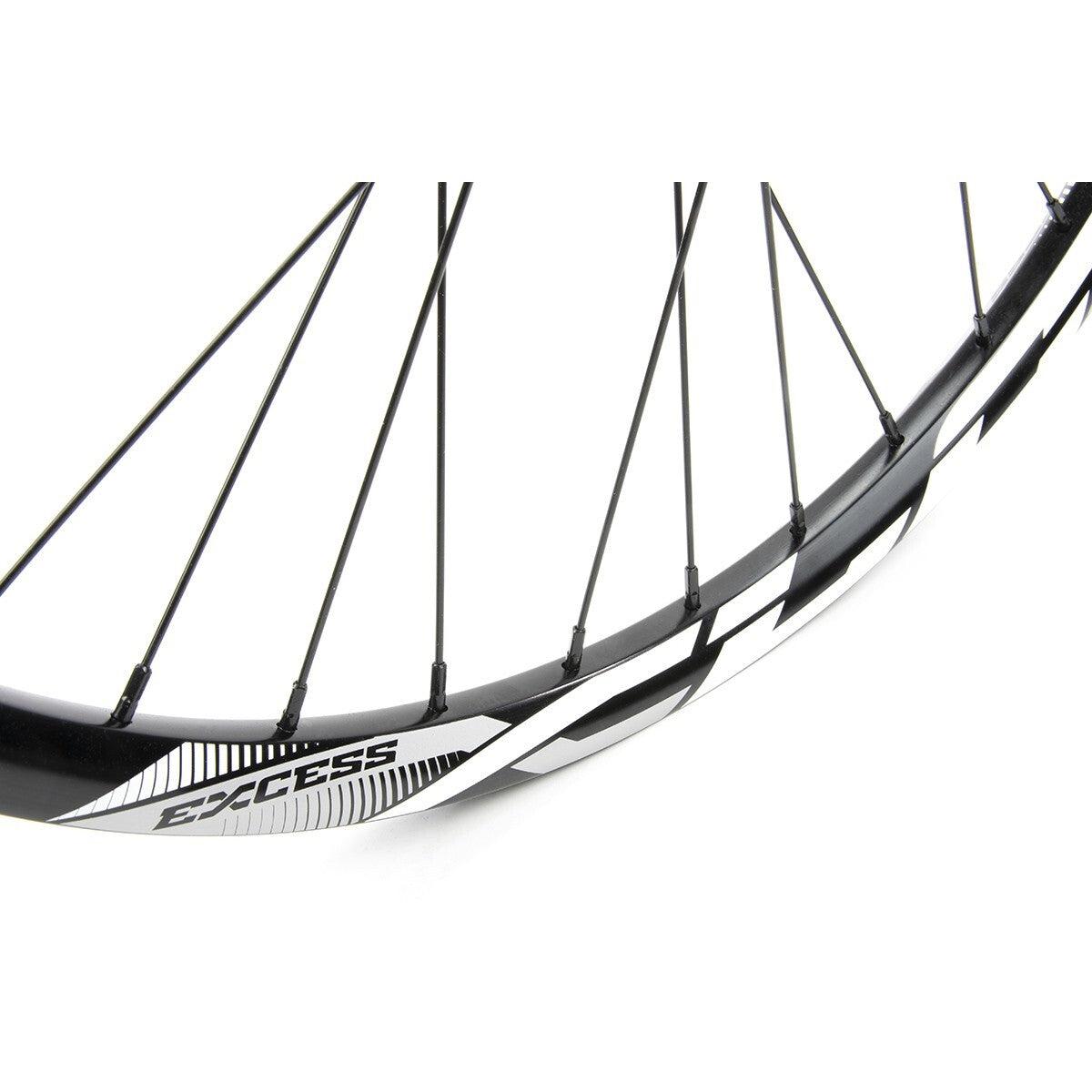 Close-up of a black Excess XLC-1 Alloy Wheel Set 28H rim with black spokes, white "EXCESS" logo, and geometric design—part of a premium BMX wheelset with a durable cassette hub.