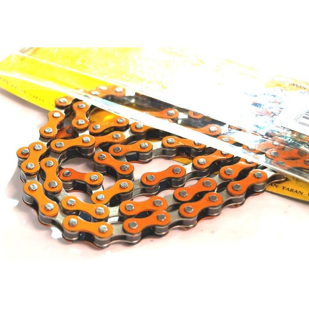 A close-up of a YBN S-410 Full Link Chain in orange and silver, partially removed from yellow packaging.