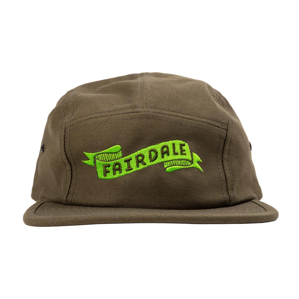 The Fairdale Banner Camper Cap is a brown cap with a neon green embroidered ribbon and "FAIRDALE" boldly displayed on the front.