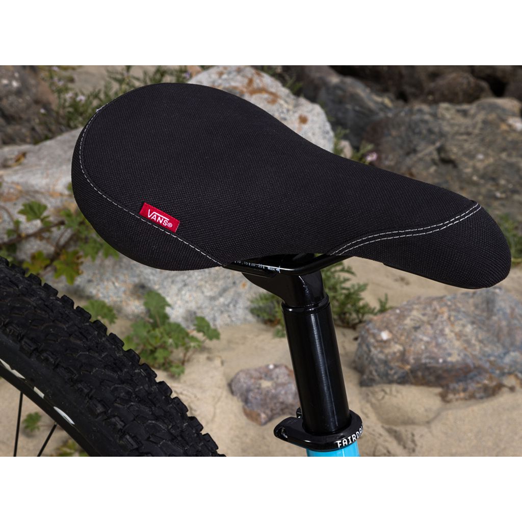 The seat of a Fairdale Taj X Vans 27.5 Inch Bike is sitting on a rock.