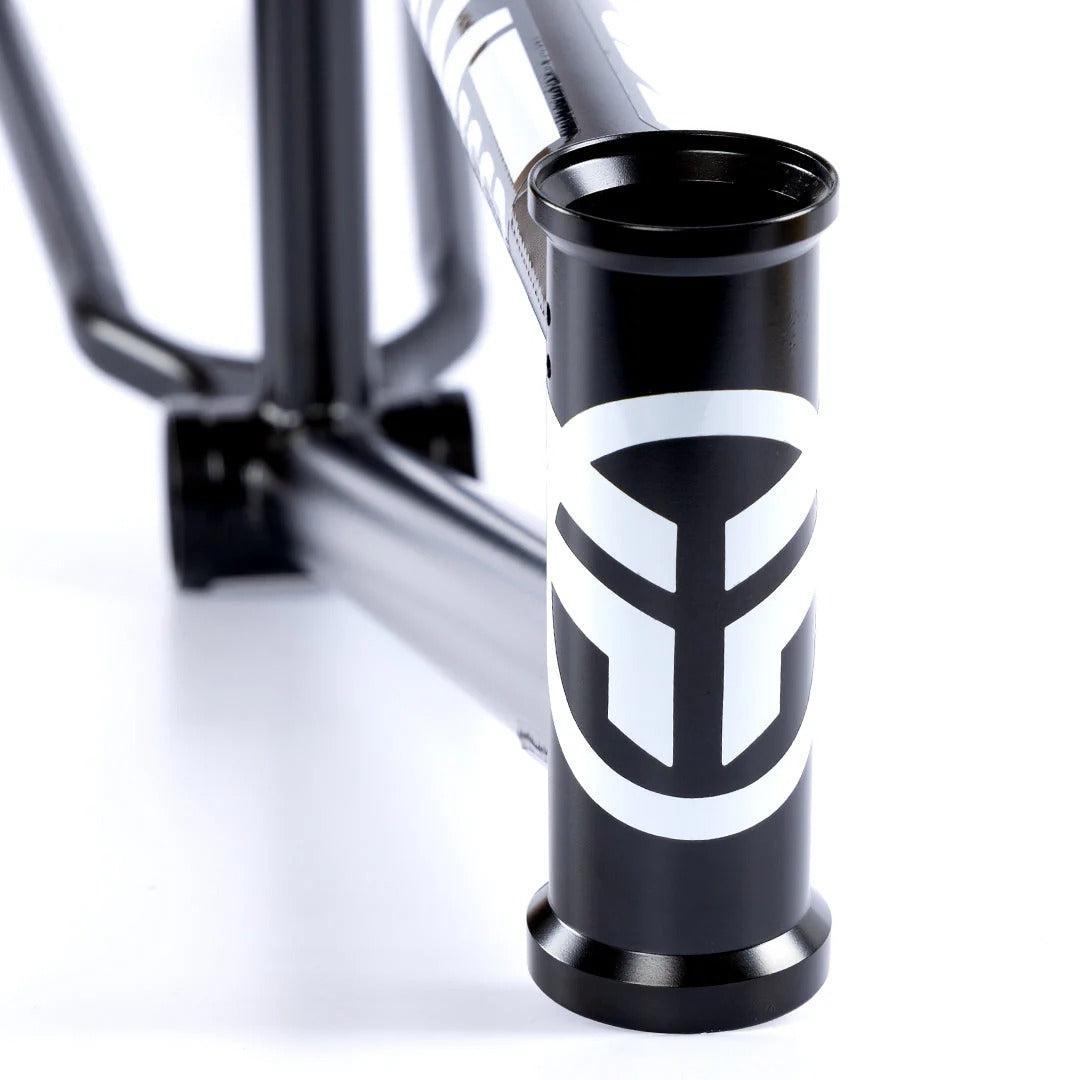 Close-up of the Federal Team ICS2 Frame’s head tube, featuring a bold white geometric logo on black 4130 Chromoly tubing—ideal for technical street riding. Set against a plain white background.