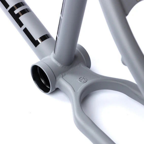Close-up of the Federal Bruno ICS2 Frame's gray bottom bracket shell and chainstay junction, showing black lettering partially visible on the 4130 Chromoly BMX frame tube.