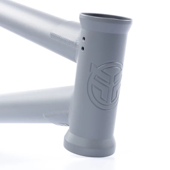 Close-up of the Federal Bruno ICS2 Frame's matte gray head tube with embossed logo, highlighting 4130 Chromoly welds and a smooth finish against a white background.