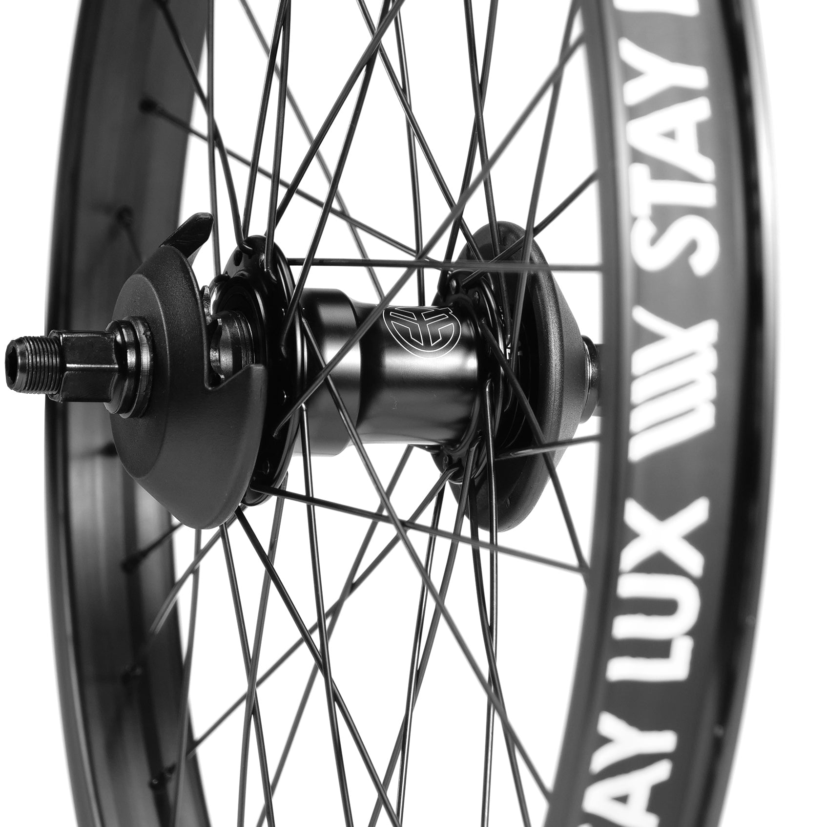 Close-up of a black bicycle wheel with white text "STAY LUX" on the rim. The Federal Motion x Odyssey Stage 2 Custom Rear Wheel hub and spokes are prominently visible, adding to its sleek design.