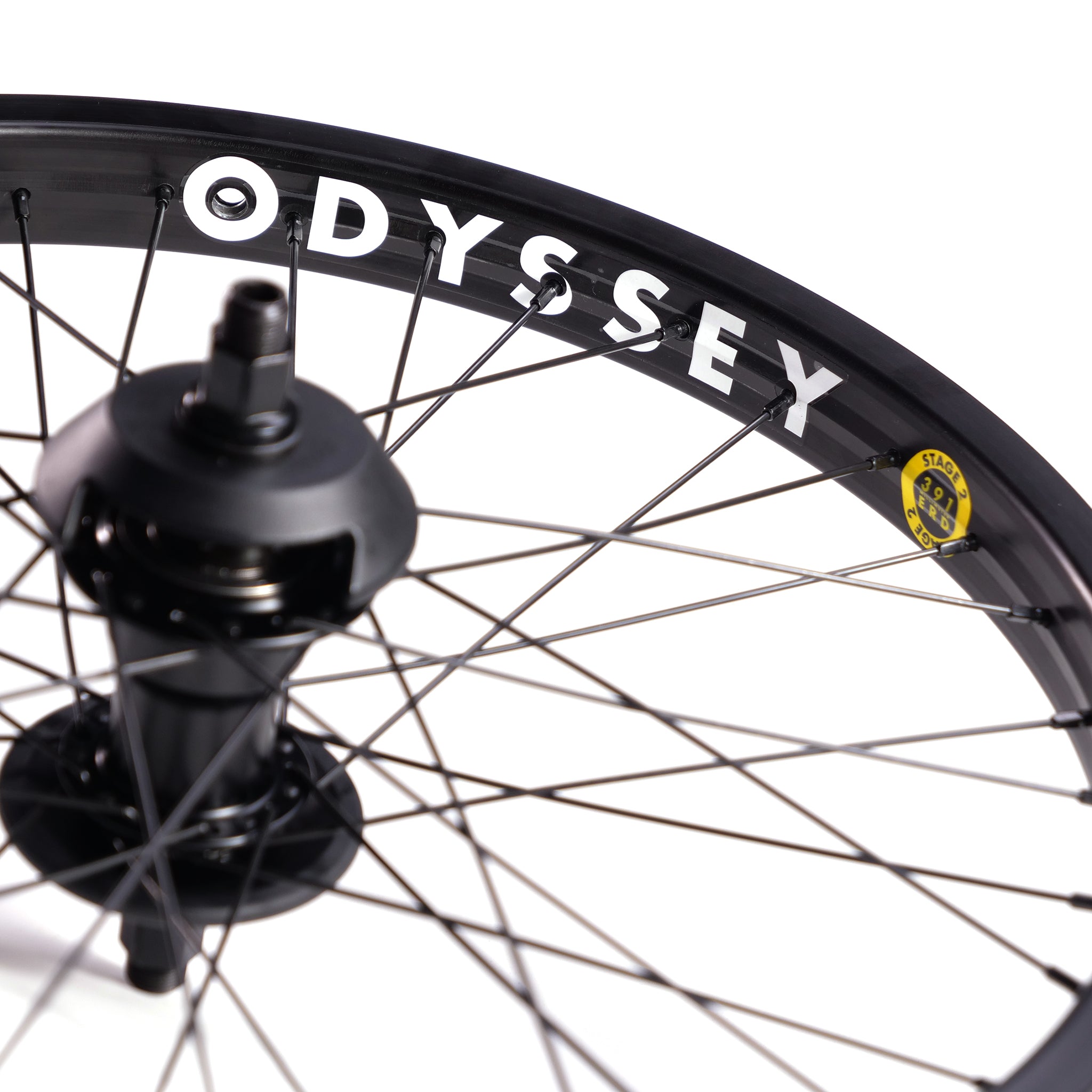 Close-up of a bicycle wheel with black spokes and a black rim labeled "ODYSSEY." The hub and part of the axle are visible in the center. Perfect for freecoaster wheels, this setup is inspired by Boyd Hilder's Federal Motion x Odyssey Stage 2 Custom Rear Wheel.