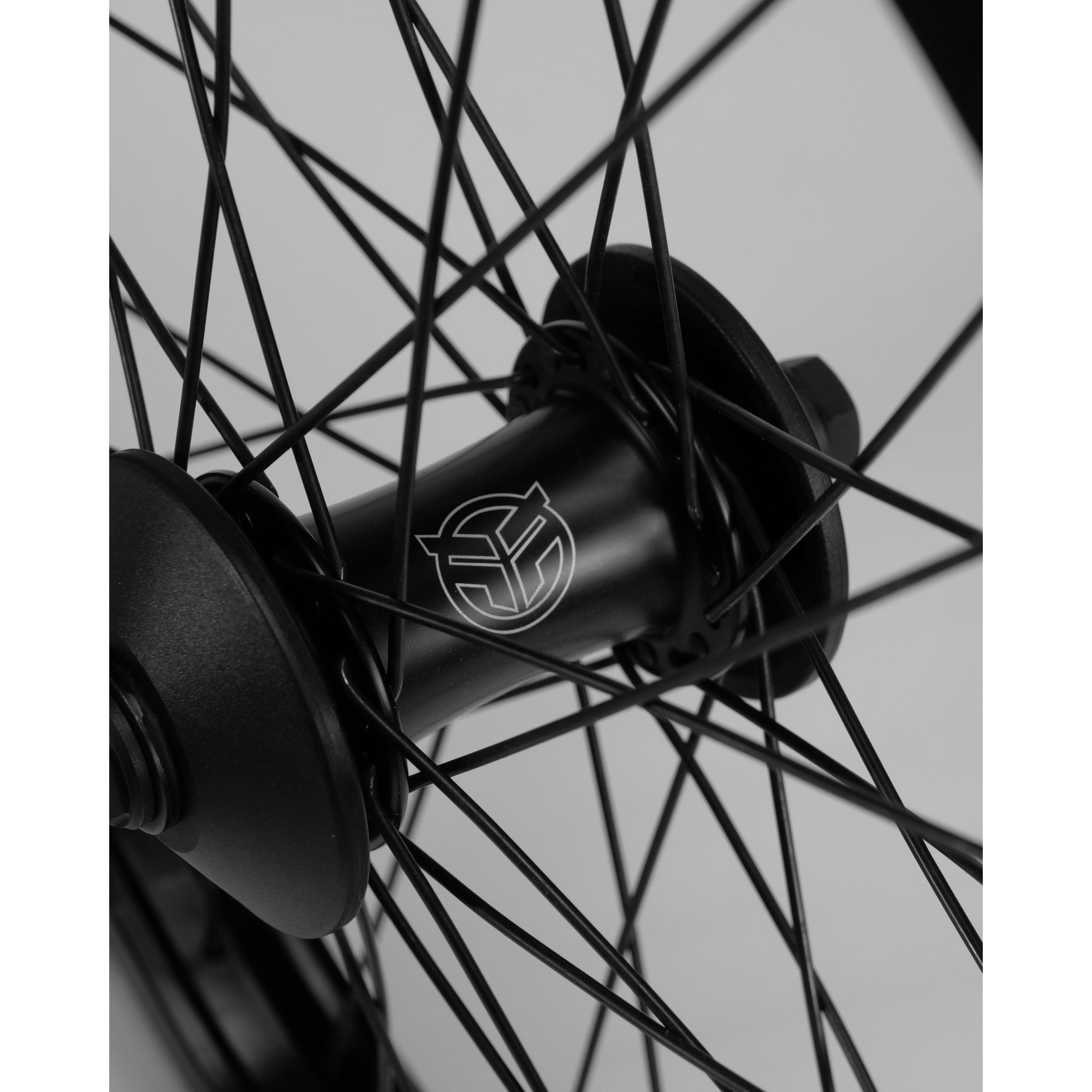Close-up of a black bicycle wheel hub with intricate spokes, featuring a Federal Stance Pro x Alienation 18 Custom Wheelset logo.