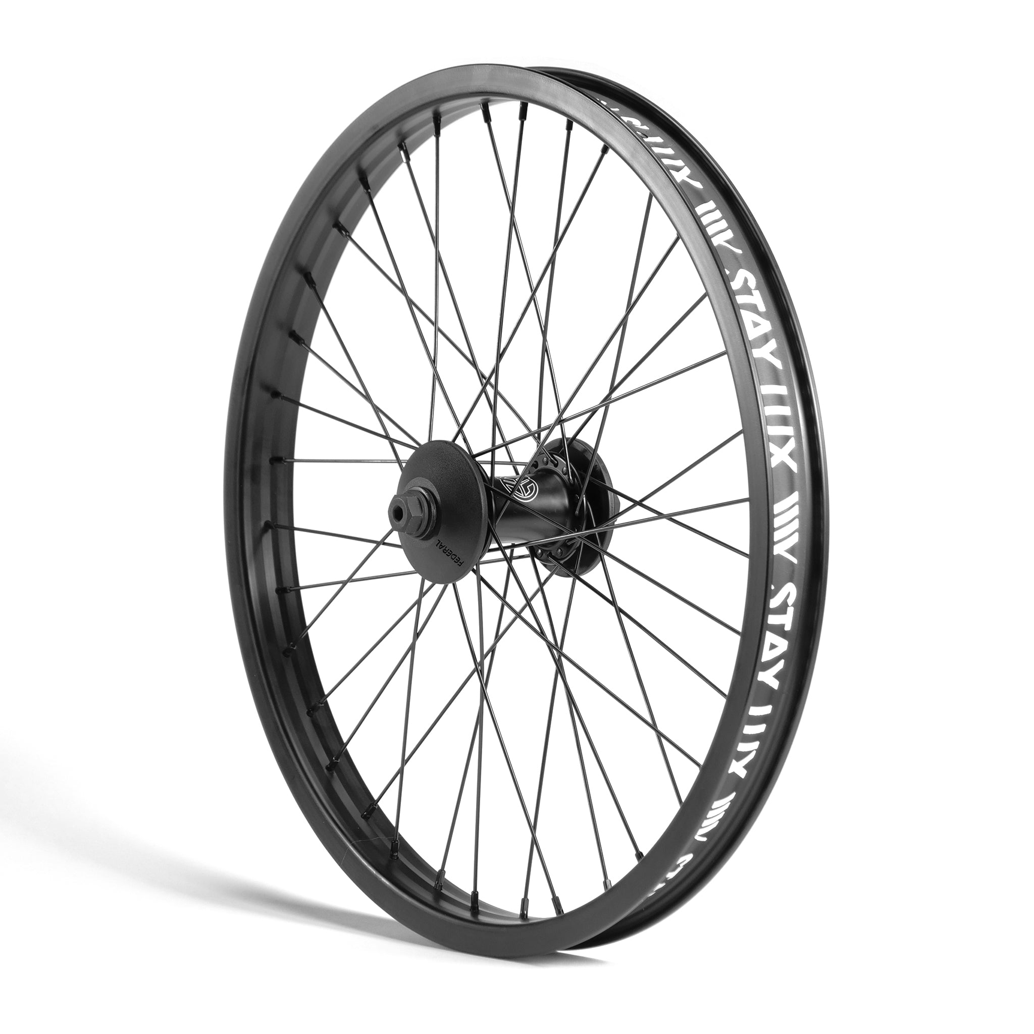 A black bicycle wheel with a multi-spoke design and the word "Stay Lux" printed repeatedly in a white font around its rim. The Federal Stance Pro x Odyssey Stage 2 Custom Front Wheel is standing upright against a white background.