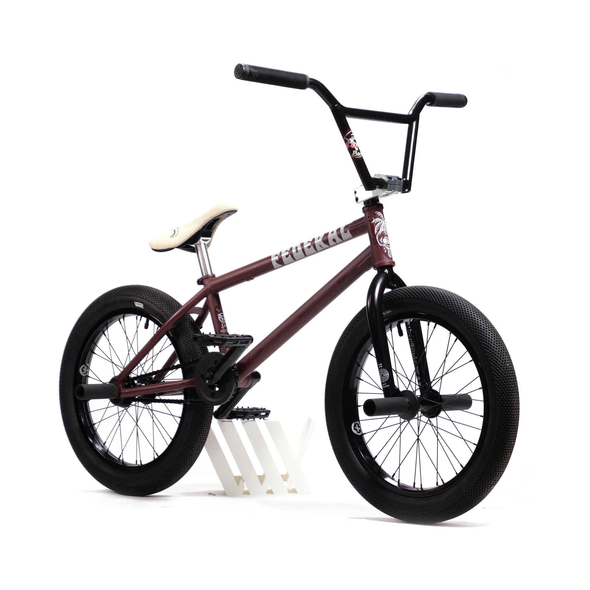 Introducing the YOUNGBOYD Custom 18 Inch Bike: This maroon BMX bike showcases black handlebars and tires, complemented by a white seat and stand. Inspired by Boyd Hilder, it’s crafted for freestyle enthusiasts who value both performance and style.
