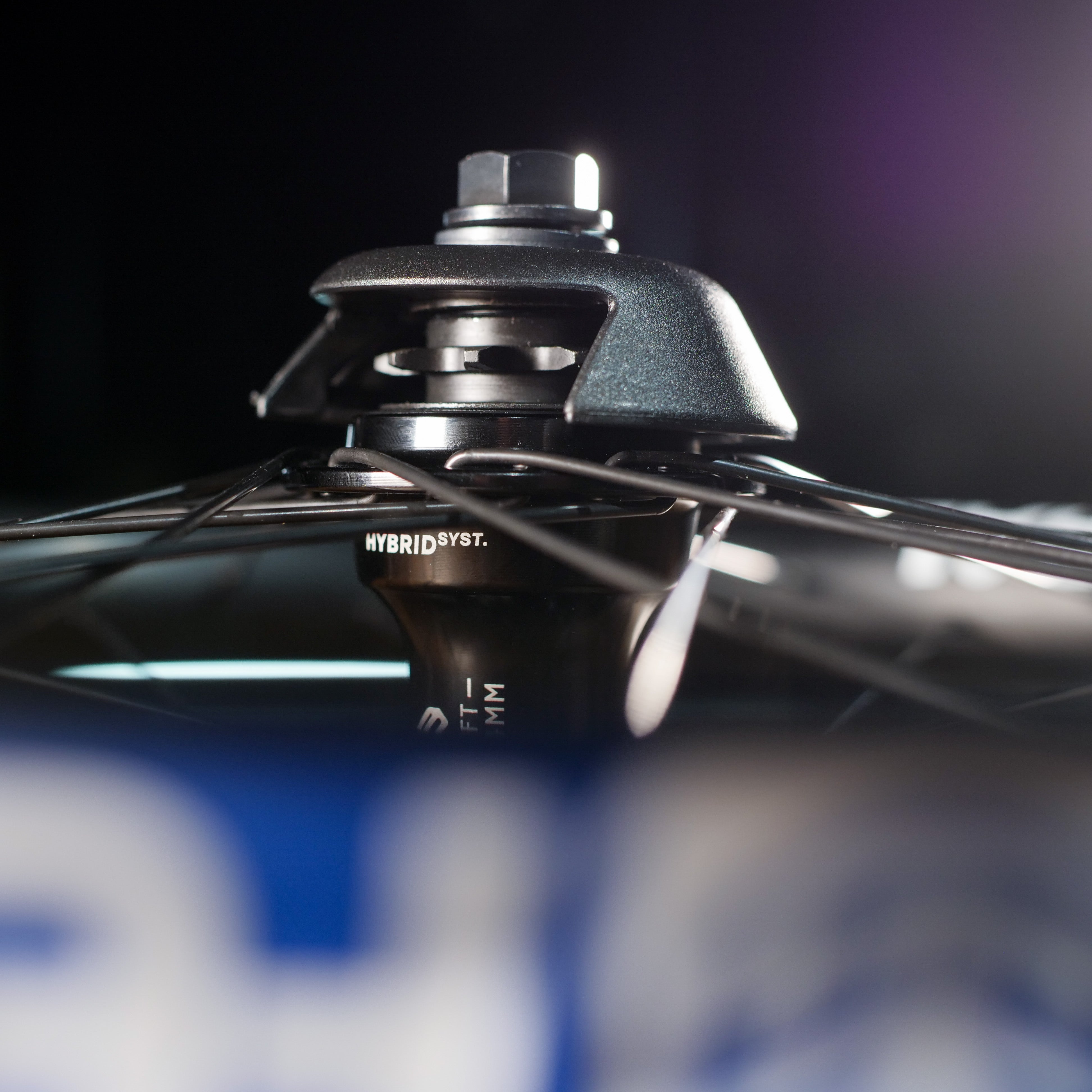 Close-up of the Federal X Eclat FM Shift Hybrid Custom Wheel hub, showcasing spokes and axle—ideal for those seeking a hybrid hub or upgrading their BMX wheel.