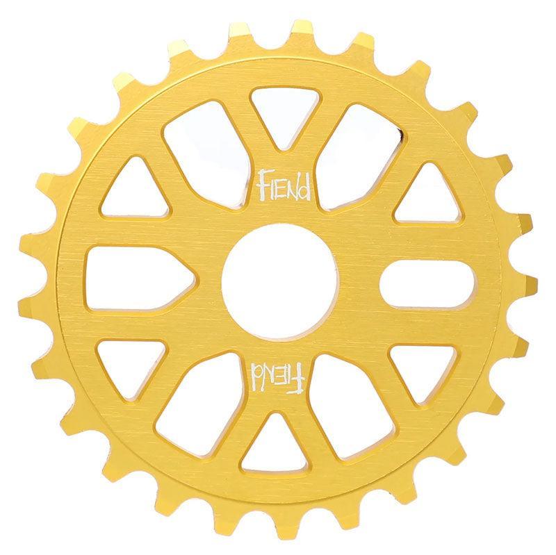 The Fiend Omicron Sprocket features a 25-tooth gold CNC-machined aluminum design with cut-out spokes and "FIEND" engraved twice at the center.