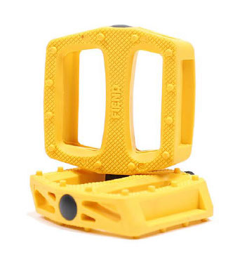 Two yellow rectangular Fiend Reynolds Pedals, made with textured nylon composite bodies and open centers—one upright, one flat—feature durable chromoly spindles for reliable cycling performance.