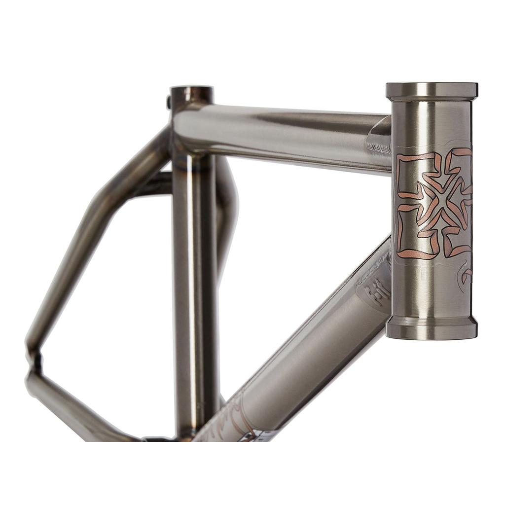 Close-up of the Fit Bike Co Mixtape Frame (Matt Nordstrom Signature), showcasing a metallic design with responsive geometry and geometric patterns on the head tube. This street frame features a brushed finish and bold angular shapes.