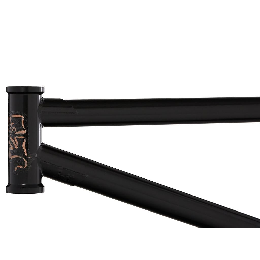Close-up of the Fit Bike Co Mixtape Frame (Matt Nordstrom Signature) in black, showcasing engraved head tube graphics. The sleek tubing and responsive geometry appear at an angle, poised for an exhilarating ride.