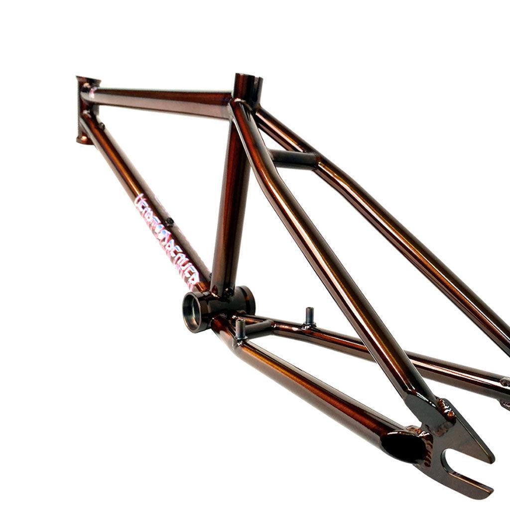 A brown BMX frame, echoing the Fit Heartbreaker Frame (Chris Harti), is showcased against a crisp white backdrop.
