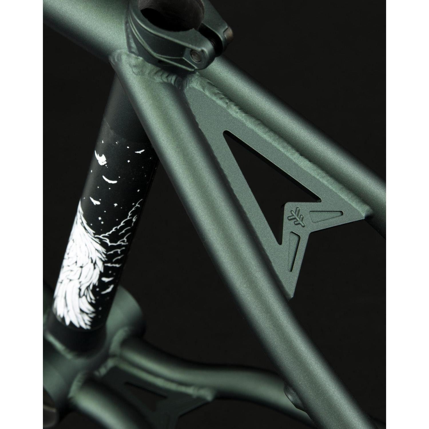 Close-up of the Fly Bikes Aire Frame, a matte green 4130 Cr-Mo bicycle frame featuring a triangular cutout and a sleek black and white design on the vertical tube, showcasing high-quality craftsmanship.