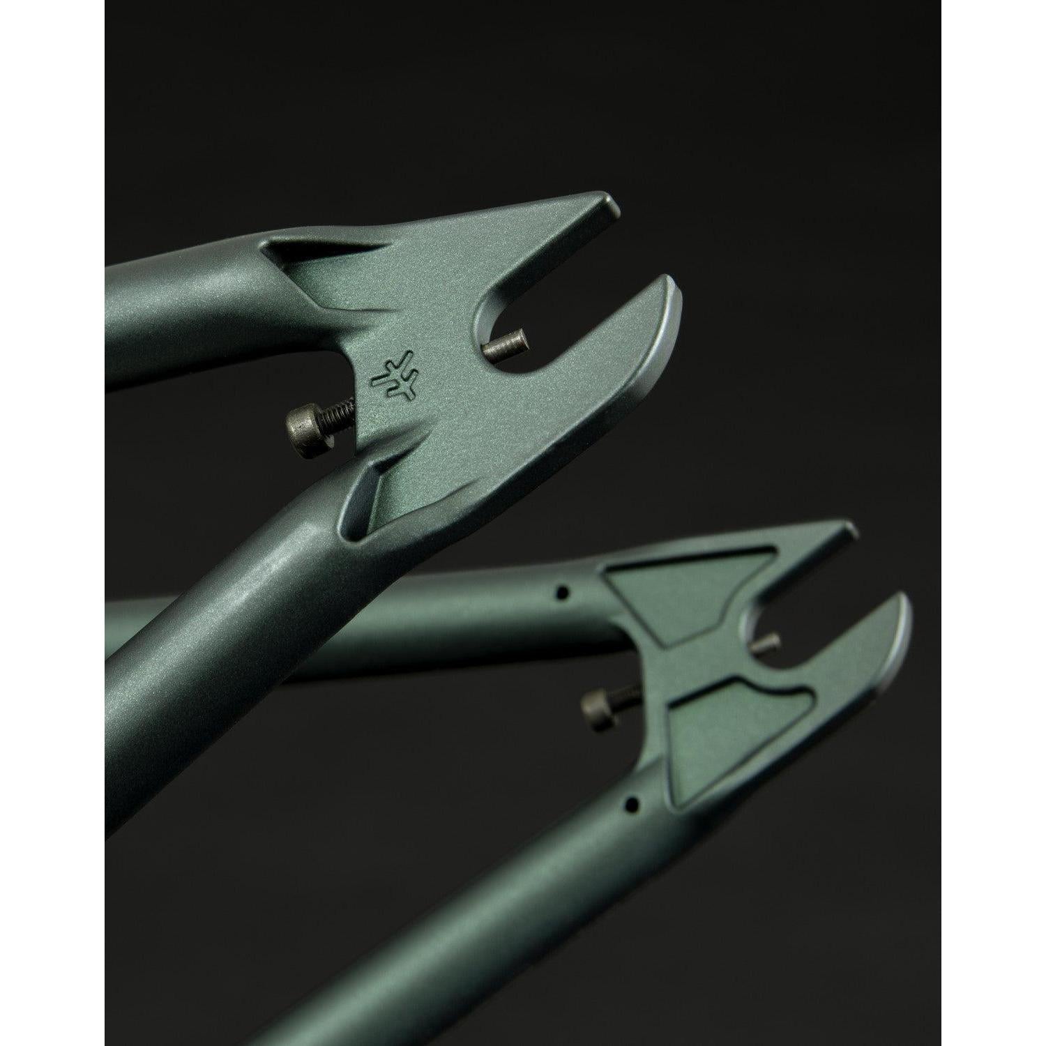 Close-up of a Fly Bikes Aire Frame in metallic green, made from 4130 Cr-Mo steel, featuring investment cast dropouts adorned with a logo.