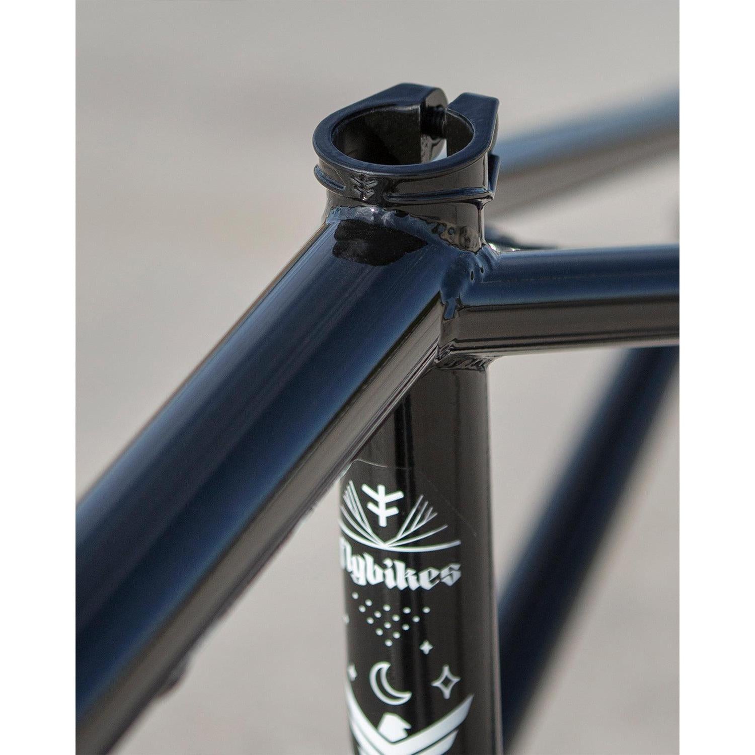 Close-up of a black Fly Bikes Dove 13.6 Frame (Josh Dove Signature) bicycle with a seat clamp, showcasing a white star and crescent moon design on the seat tube, perfect for transition riding.