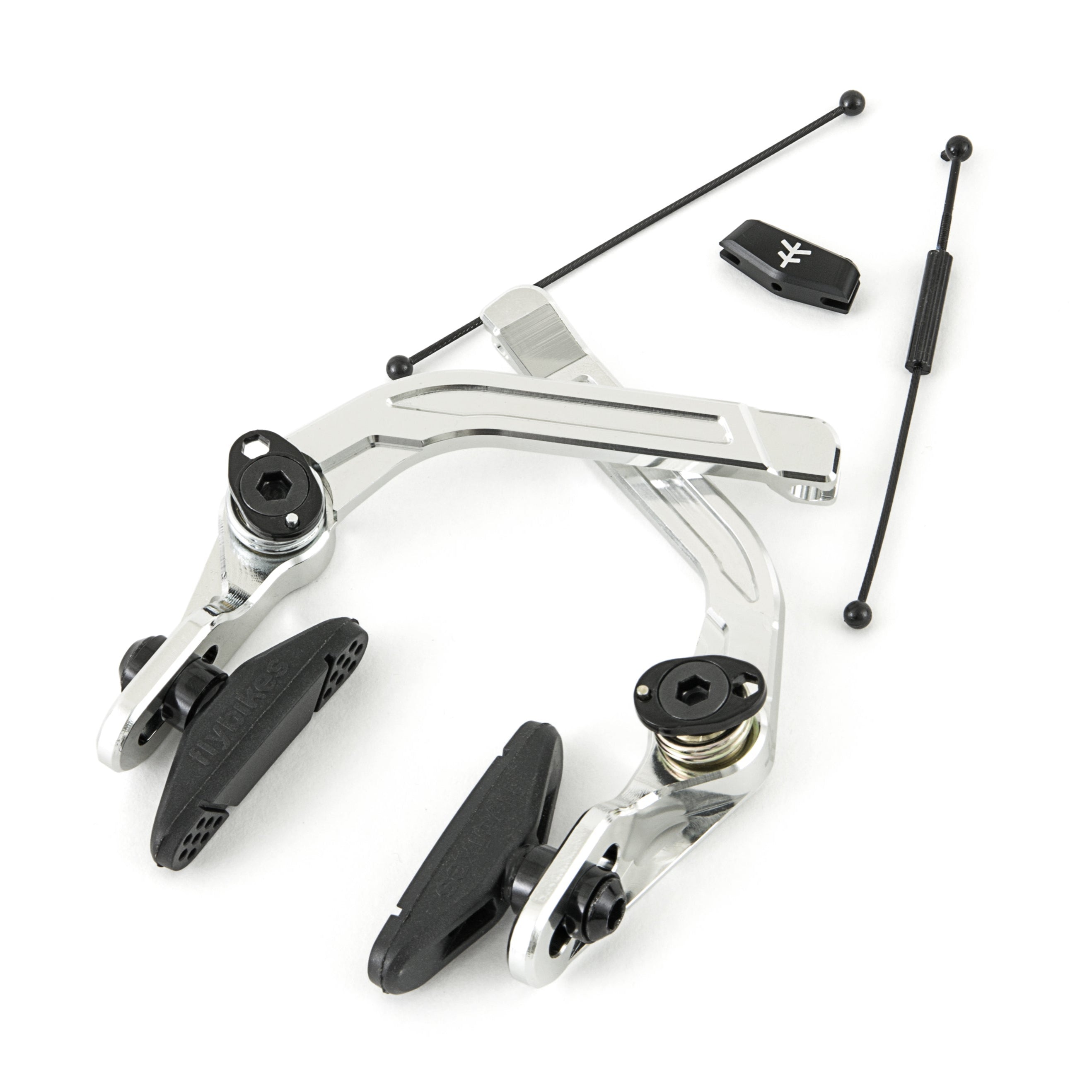 The Fly Bikes Manual CNC Brake in silver includes a brake caliper and pads, featuring an adjustable A-Hanger and small additional components on a white background.