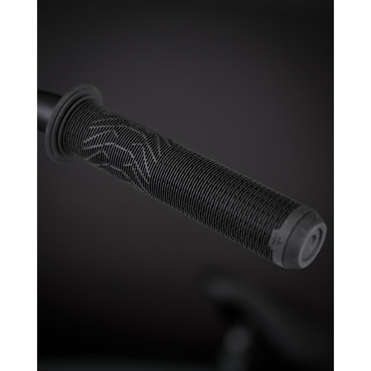 Close-up of the handlebar grip on a Fly Bikes Neutron 20 Inch Bike, showcasing the textured surface and subtle pattern against a dark background.