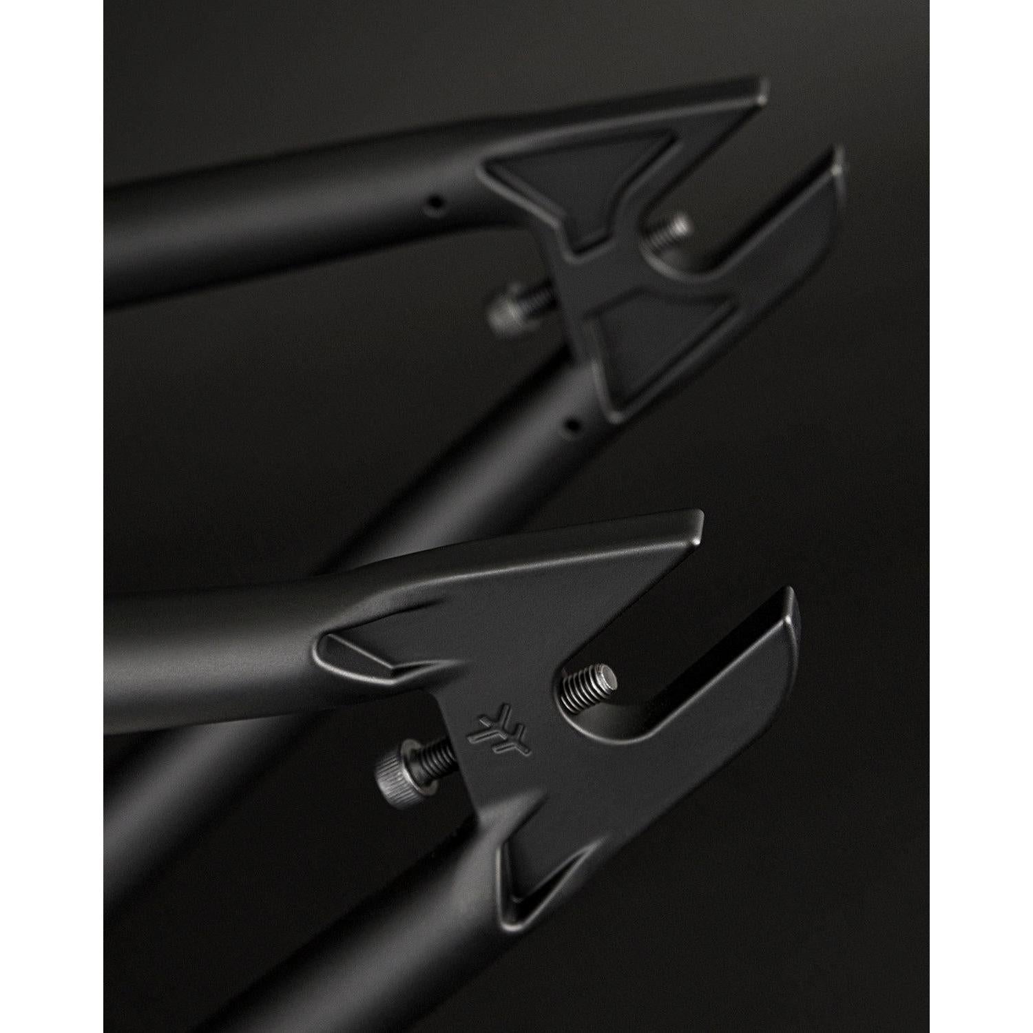 Close-up of black bicycle dropouts with a sleek, modern design against a dark background, showcasing the Fly Bikes Sierra 18 Inch BMX frame.