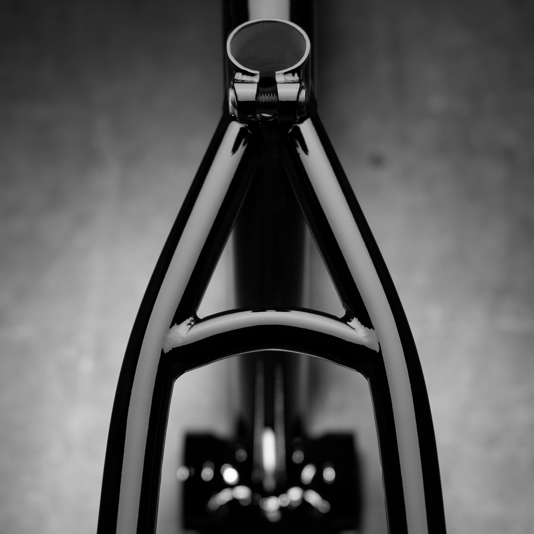 Close-up, top-down view of the Kink Prophet Frame in black, highlighting its chromoly rear triangle and seat tube against a blurred gray background.