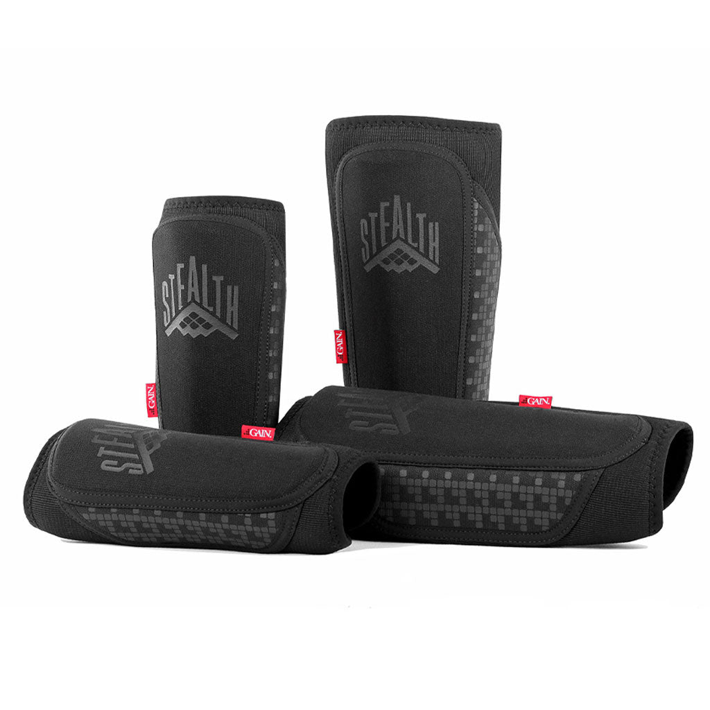 Two black GAIN STEALTH Shin Guards are shown in various upright and horizontal positions against a white background.