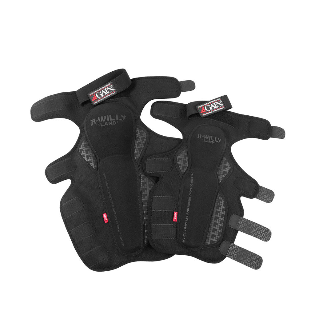 A pair of GAIN x R WILLY LAND "PROGRESSION" V2 Knee/Shin Combo Pads, black with multiple straps and branded labels, displayed side by side on a white background—ideal protective gear for BMX riders.