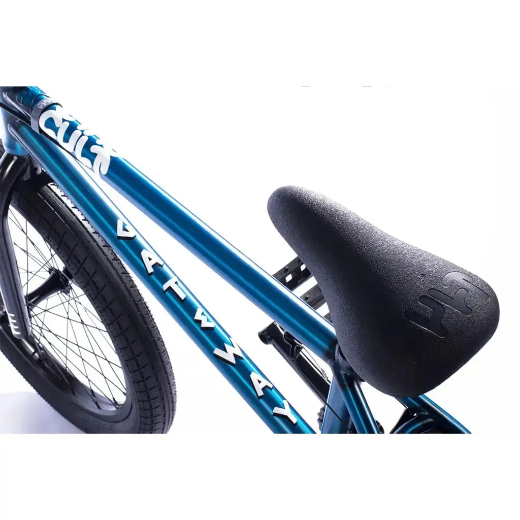 Close-up of a blue Cult Gateway 20 Inch bike frame with white branding, a black seat, and a rear wheel.