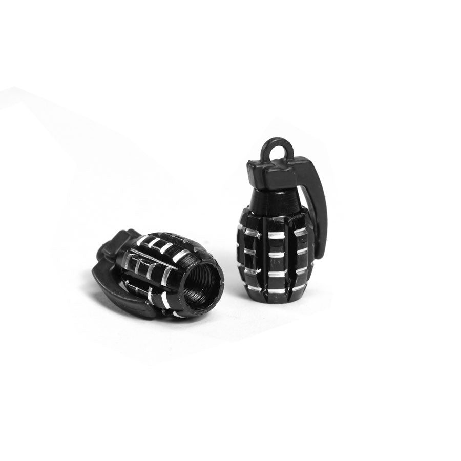 A pair of black metal Grenade Valve Caps with silver accents are displayed against a white background—one stands upright, the other lies on its side.