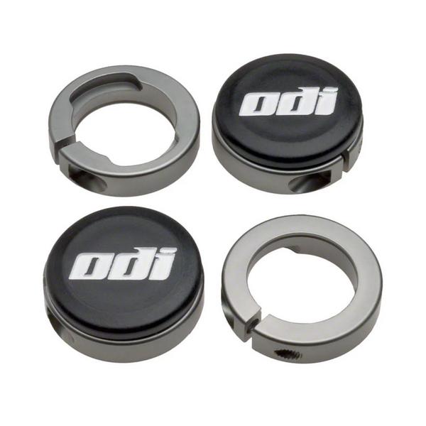 Four round metal locking rings and two black end caps with the "odi" logo, for Tangent Contour Lock On Grips, are arranged in a square pattern on a white background—ideal replacement parts for slim fit or Tangent grips.