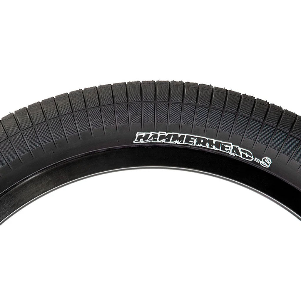 Close-up of a black tire with "Hammerhead - Street (S)" imprinted on the sidewall, highlighting the lightweight and durable design of the Mike "Hucker" Clark Signature Tire.