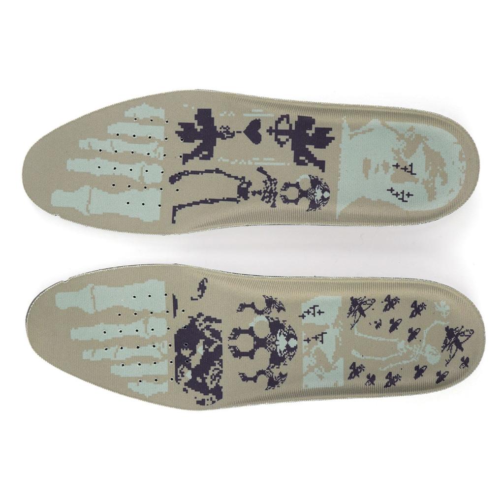 Two beige insoles with foot bone and skull prints in dark blue and light green, inspired by BMX slip-ons. Designed to pair perfectly with Higher Salem Suede Slip On Shoes.