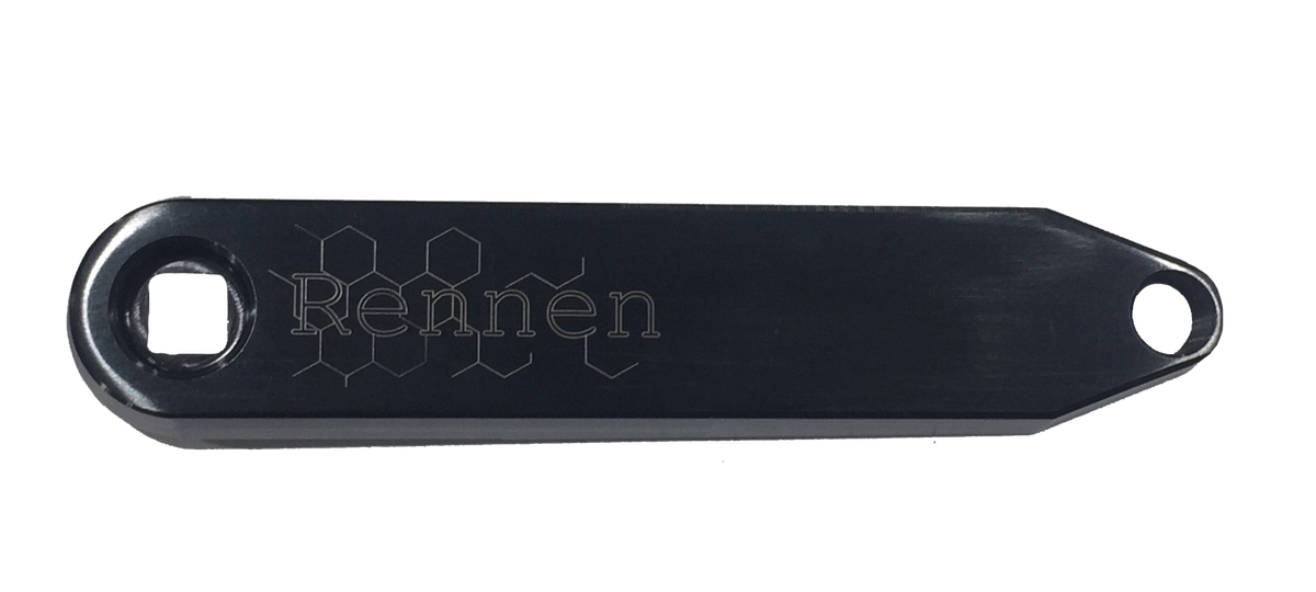 Crafted from high-strength 7075-T6 Aluminum, the black metal lever features the word “Rennen” and a distinctive hexagonal pattern engraved into its surface. Its design incorporates a square hole on the left and a round hole on the right, echoing key elements of the Rennen Hive Mini Square Tapered Cranks—one of the lightest square taper crank options available.