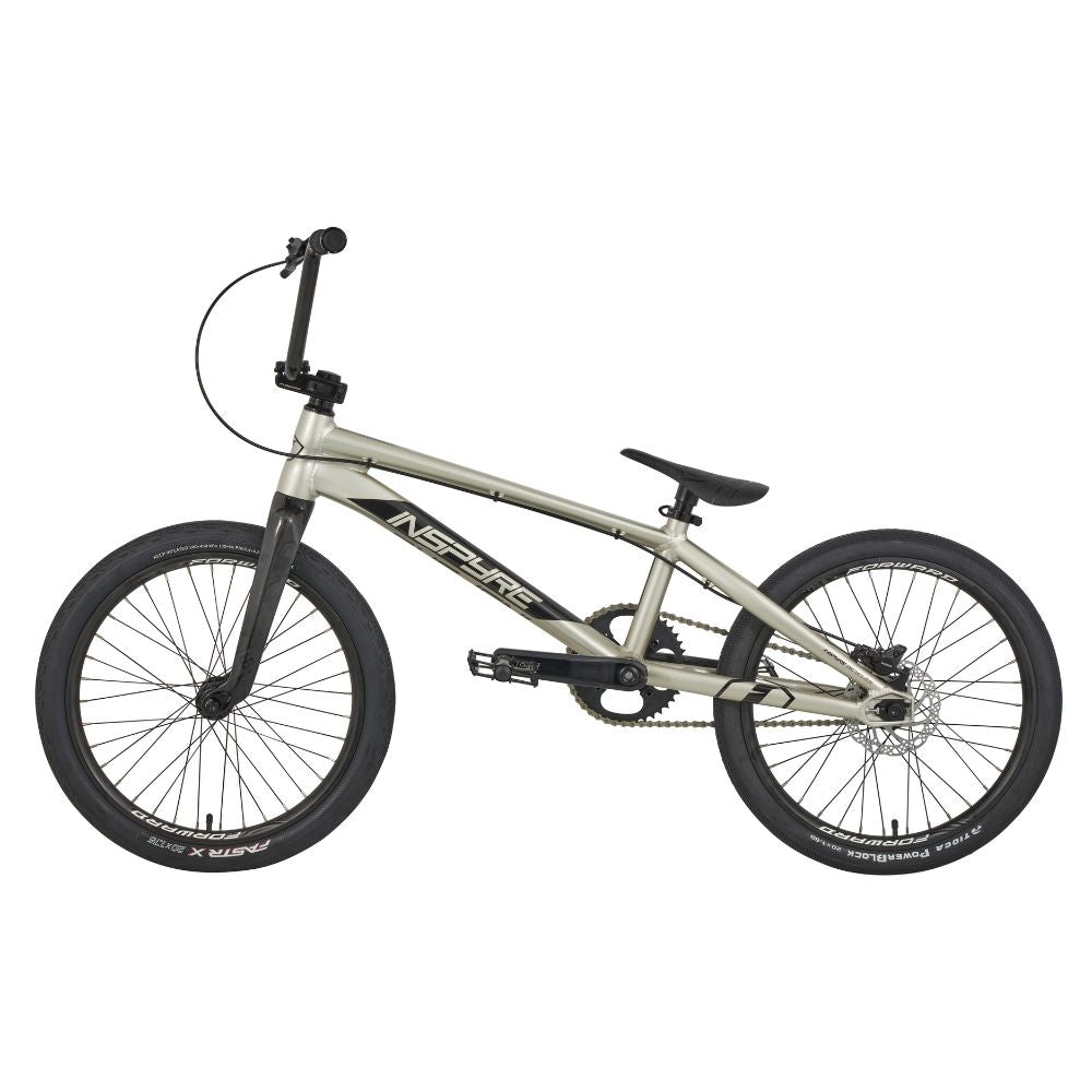 The Inspyre Evo-C Disc Pro L Bike 2025 is a silver BMX, featuring black handlebars and wheels with "Inspyre" on the frame, exemplifying classic race geometry. Perfect for BMX racing aficionados, it offers both performance and style.